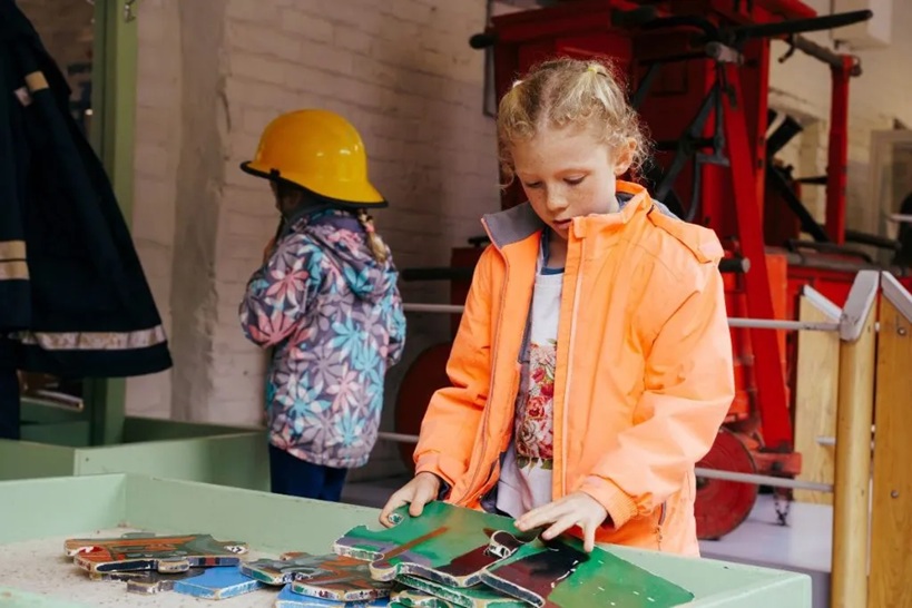 Two children interacting with an exhibition