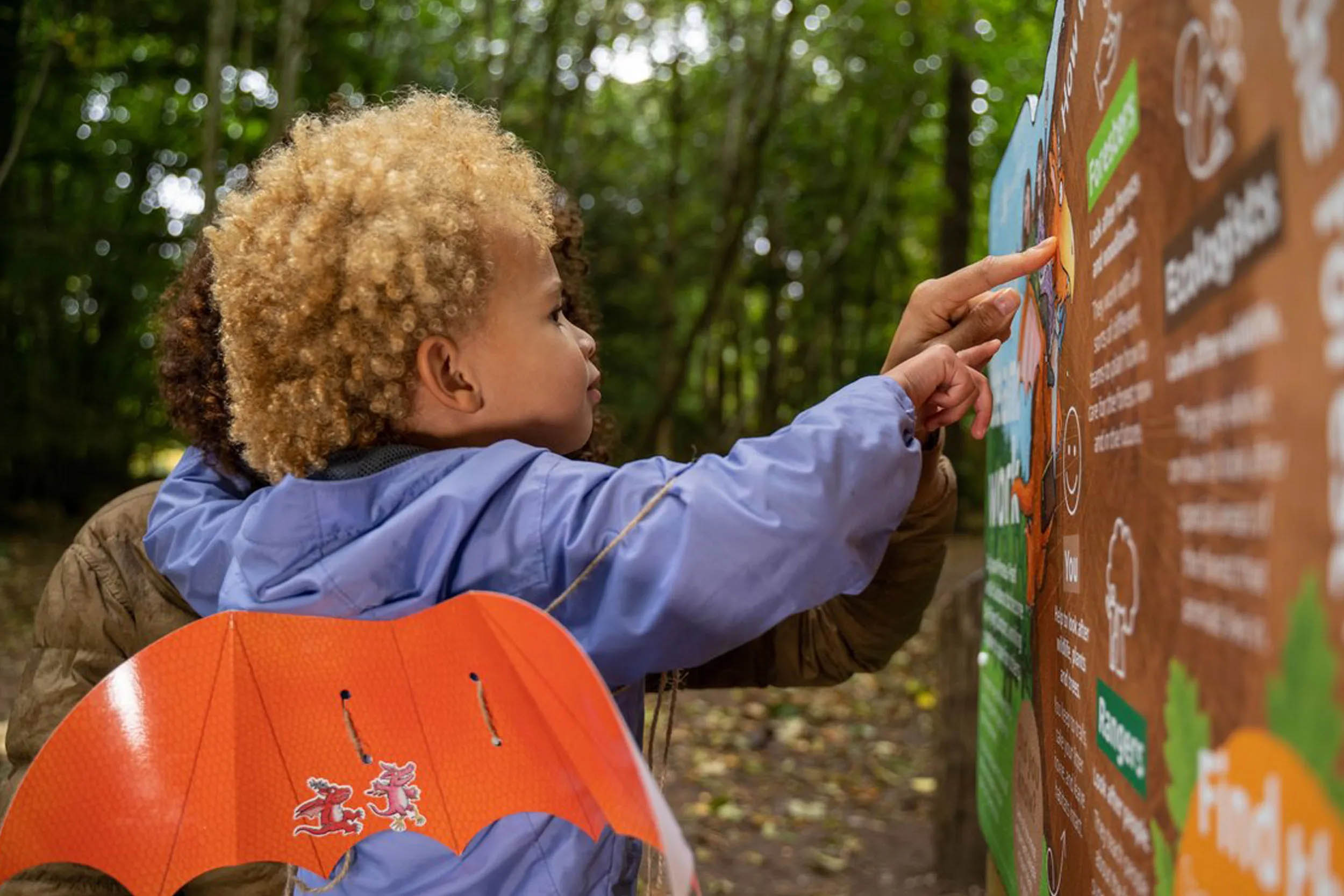 A child pointing at a sign