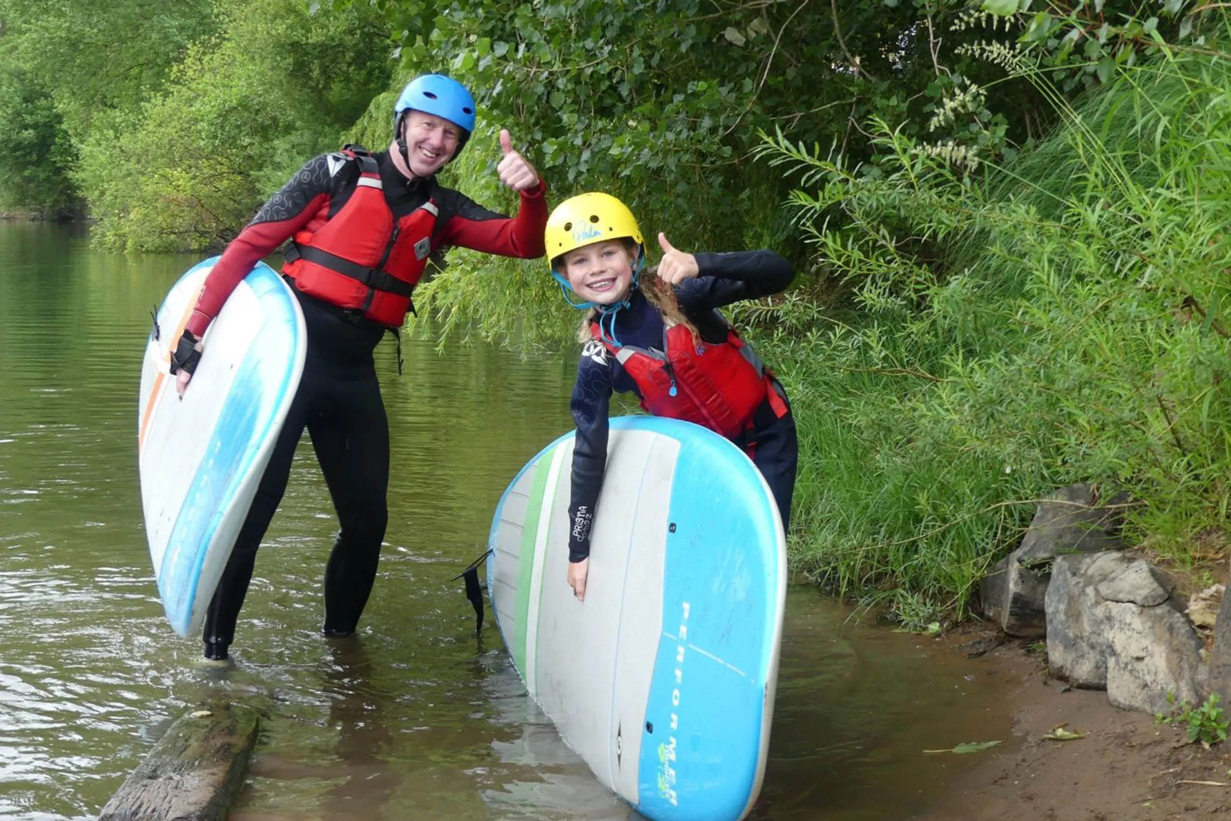 Two people with surfboards