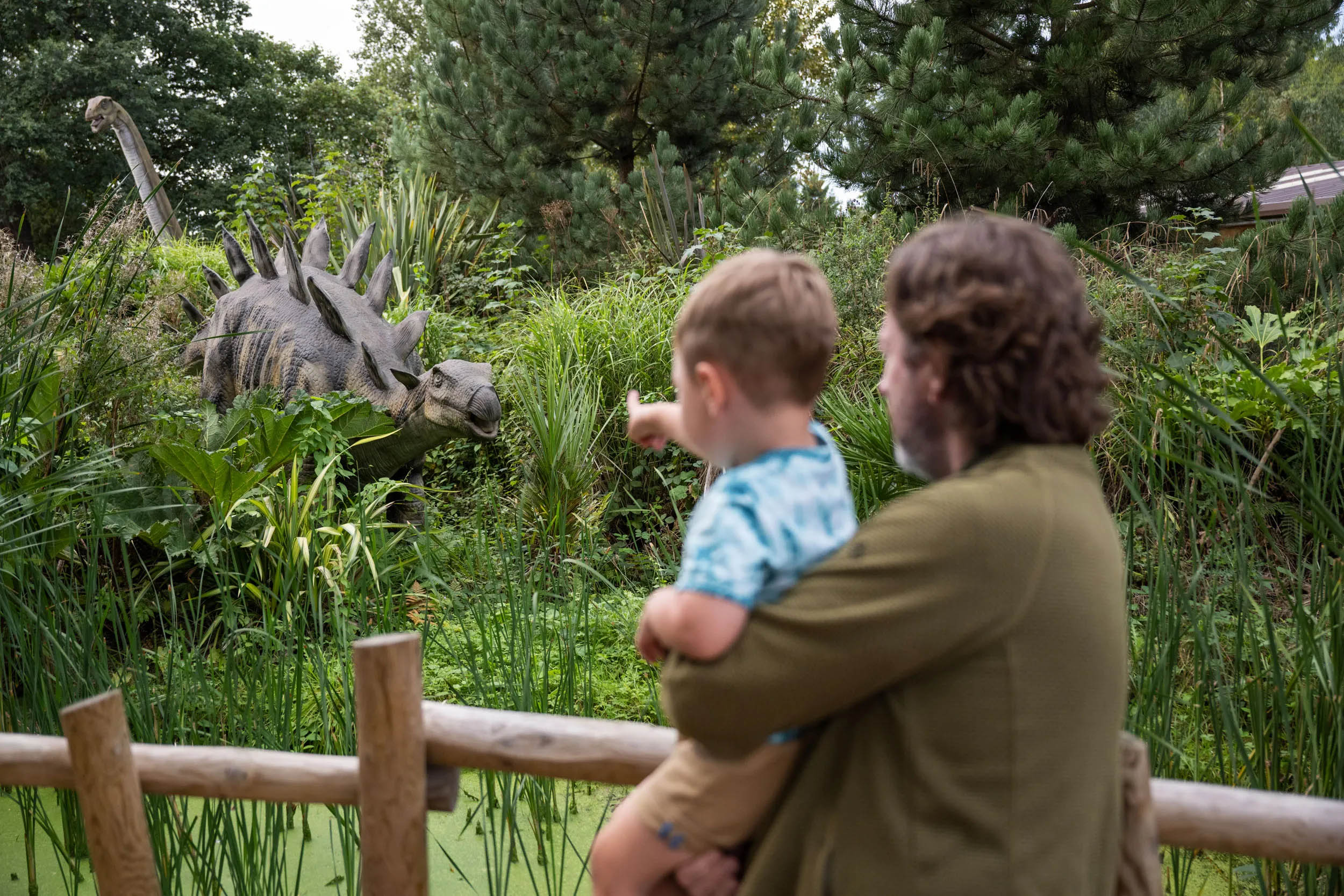 Two people looking at a model of a dinosaur